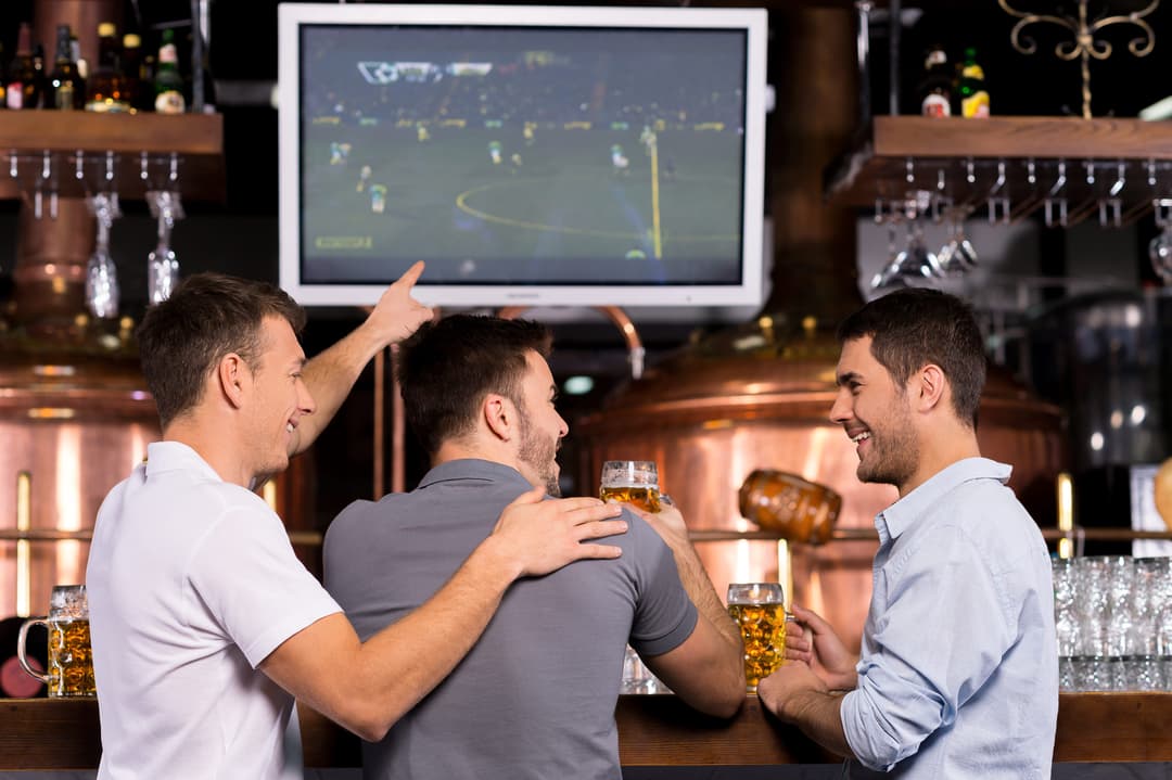 Guests watching sports and socializing at the bar